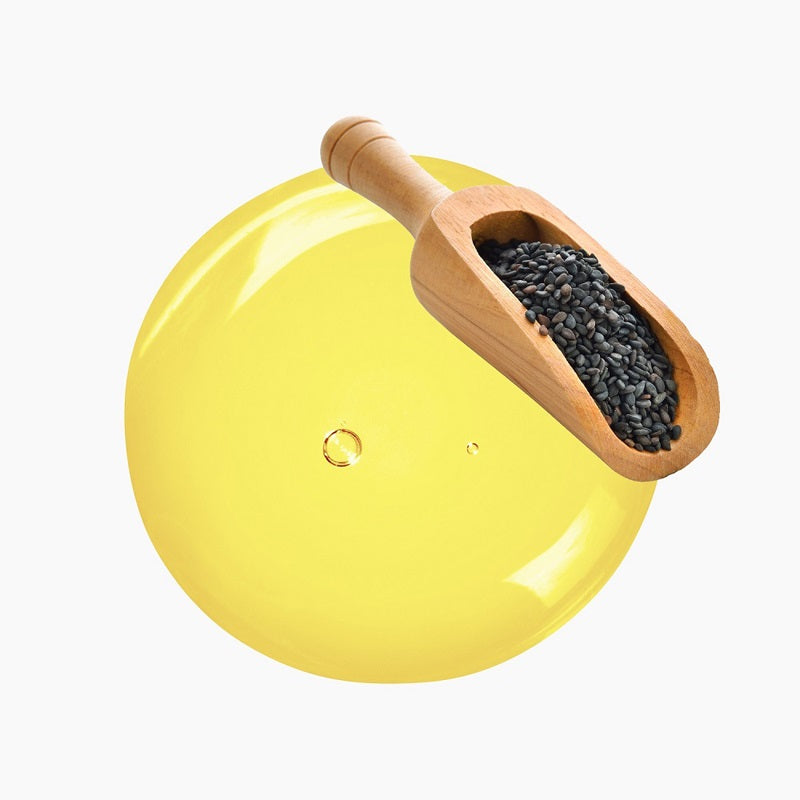 Wooden Spoon With A Scoop Of Black Seeds Atop A Circular Blob Of Yellow Oil | Bulk Oils | Brightpack Raw Materials