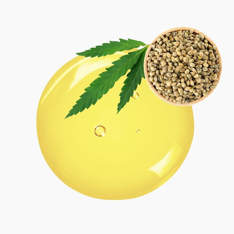 Hempseeds On Wooden Bowl Atop A Circular Blob Of Yellow Oil | Bulk Oils | Brightpack Raw Materials